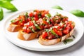 tomato and basil bruschetta on a white ceramic plate Royalty Free Stock Photo