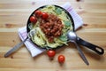 Tomato and Basil pasta cooking in a pan gourmet, homemade dish on a wooden table Royalty Free Stock Photo