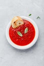 Tomato basil soup with bread toasts on gray stone background Royalty Free Stock Photo