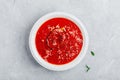 Tomato basil soup with parmesan cheese on gray stone background Royalty Free Stock Photo