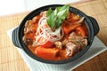 Tomato and Beef Brisket Casserole noodles served in borth isolated on table top view of Claypot Royalty Free Stock Photo