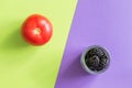 Tomato and blackberry on a green-purple background