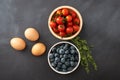 Tomato , blue berry and egg on bowl in chalkboard background