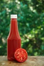 Tomato and bottle of ketchup Royalty Free Stock Photo