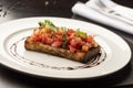 Tomato bruschetta with basil and parsley on white plate Royalty Free Stock Photo