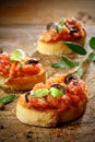 Tomato bruschetta topped with olive and basil