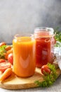 Tomato and carrot juice in a glasses on a stone table. Vitamins drinks juice carrot and tomato. Healthy lifestyle. Copy space Royalty Free Stock Photo