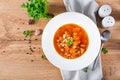 Tomato chicken soup with pumpkin and white beans in white bowl. Royalty Free Stock Photo