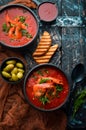 Tomato cream soup with shrimps in a black bowl. Seafood menu. Top view. Royalty Free Stock Photo