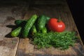 Tomato, cucumber and dill on a rustic wooden table Royalty Free Stock Photo