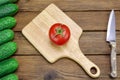 Tomato, Cucumbers And Kitchen Knife On The Rough Wood Background