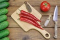 Tomato, Cucumbers, Knife And Hot Peppers On The Wood Background