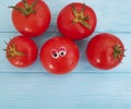 Tomato funny eyes cartoon on blue wooden positive emotion
