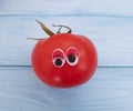 Tomato funny organic cute person eyes cartoon on blue wooden positive emotion