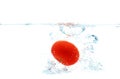 Tomato falling or dipping in water with splash Royalty Free Stock Photo