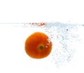 Tomato falling or dipping in water with splash Royalty Free Stock Photo