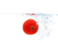 Tomato falling or dipping in water with splash Royalty Free Stock Photo