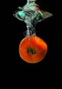 Tomato is falling into water Royalty Free Stock Photo