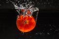 Tomato falling in water Royalty Free Stock Photo