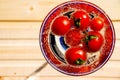 Tomato floats in water with bubbles in glass glass glass on white background.