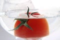 Tomato floats in water with bubbles in glass glass glass on white background