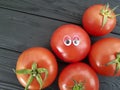 Tomato funny cartoon on black wooden