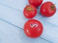 Tomato funny cartoon on blue wooden positive emotion