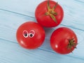 Tomato funny cartoon on blue wooden positive