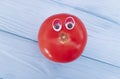 Tomato funny organic eyes cartoon on blue wooden positive emotion