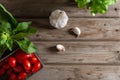Tomato, garlic and herbs. Ingredients for cooking. Food background on old wooden table. Top view copy space Royalty Free Stock Photo