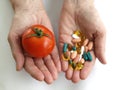 Tomato and handfull of pills Royalty Free Stock Photo