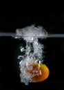 Tomato immersed in water, on black background Royalty Free Stock Photo