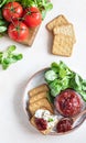 Tomato jam, confiture or sauce in glass jar with crackers and green leaves salad. Unusual savory jam. Mediterranean cuisine Royalty Free Stock Photo