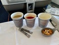 Moscow, Russia - August, 2020: Tomato juice and cappuccino with nuts on the board an Aeroflot aircraft in business class Royalty Free Stock Photo