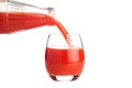 Tomato juice is flowing into a glass isolated on white Royalty Free Stock Photo