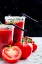 Tomato juice garnished with a rosemary branch and fresh ripe red cherry tomatoes Royalty Free Stock Photo