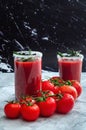 Tomato juice garnished with a rosemary branch and fresh ripe red cherry tomatoes Royalty Free Stock Photo