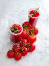 Tomato juice garnished with a rosemary branch and fresh ripe red cherry tomatoes Royalty Free Stock Photo