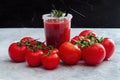 Tomato juice garnished with a rosemary branch and fresh ripe red cherry tomatoes Royalty Free Stock Photo