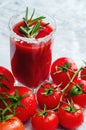 Tomato juice garnished with a rosemary branch and fresh ripe red cherry tomatoes Royalty Free Stock Photo