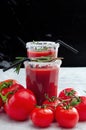 Tomato juice garnished with a rosemary branch and fresh ripe red cherry tomatoes Royalty Free Stock Photo