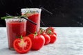 Tomato juice garnished with a rosemary branch and fresh ripe red cherry tomatoes Royalty Free Stock Photo