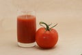 Tomato juice and tomato against beige background