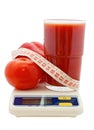 Tomato juice, vegetables, measuring tape on electr Royalty Free Stock Photo