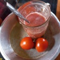 Tomato juice whose main ingredients are white sugar tomatoes and ice cubes