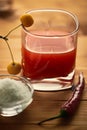 Tomato juice on a wooden table and apples on the glass