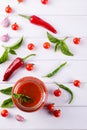 Tomato ketchup sauce with cherry tomatoes and red hot chili peppers, garlic and herbs in a glass jar on white background. Royalty Free Stock Photo