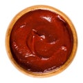 Tomato ketchup in wooden bowl over white Royalty Free Stock Photo