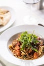 Tomato linguine with meat and ruccola served in a fancy plate Royalty Free Stock Photo