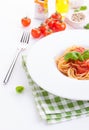 Tomato pasta spaghetti with fresh tomatoes, basil, italian herbs and olive oil in a white bowl Royalty Free Stock Photo